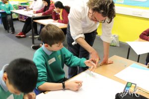Image of artist working with students