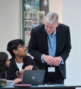 Image of the Headteacher congratulating students on their exam results