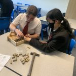 Image of student building a bug hotel