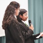 Two Students delivering speech in front of audience
