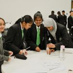 Y7 students building a bridge out of straws and tape