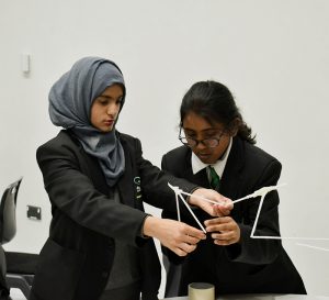 Year 7 students building a bridge out of straws and tape