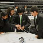 Y7 students building a bridge out of straws and tape