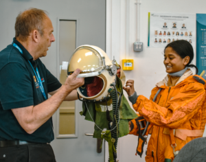 Student wearing astronaut suit and UK Space Academy guest