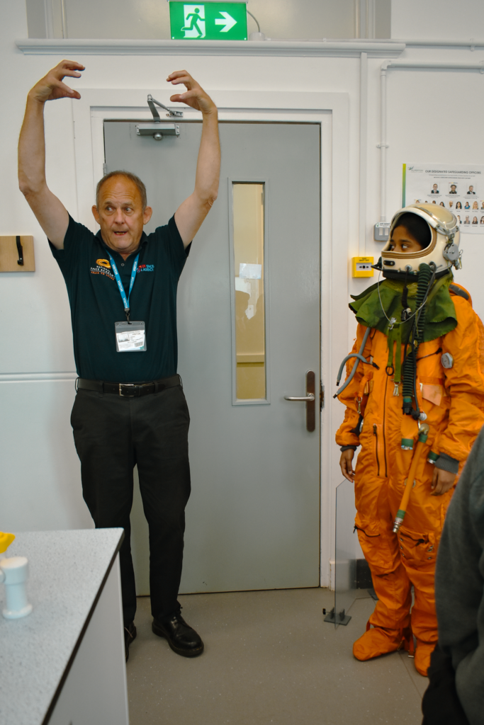 Student wearing astronaut suit and UK Space Academy guest