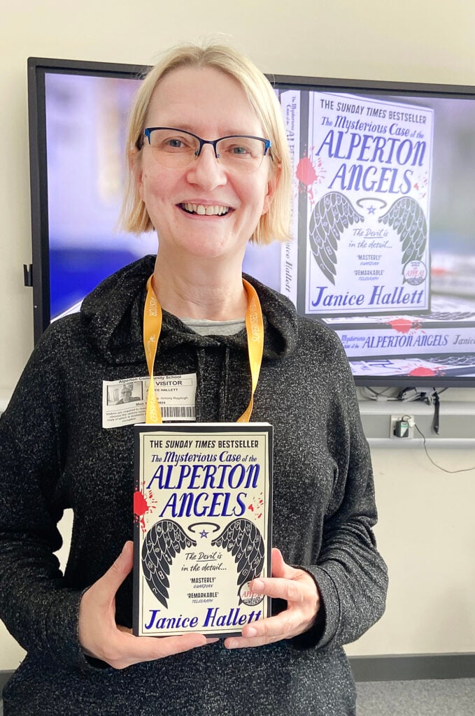 Author Janice Hallett holding her book 'Alperton Angels'