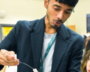 Science teacher performing science experiment