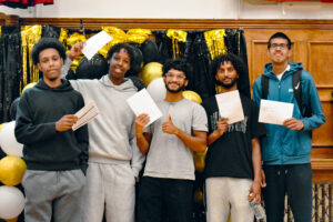 Students proudly holding their results
