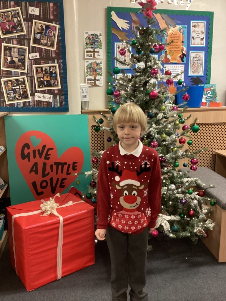 Child standing in front of a Christmas Tree