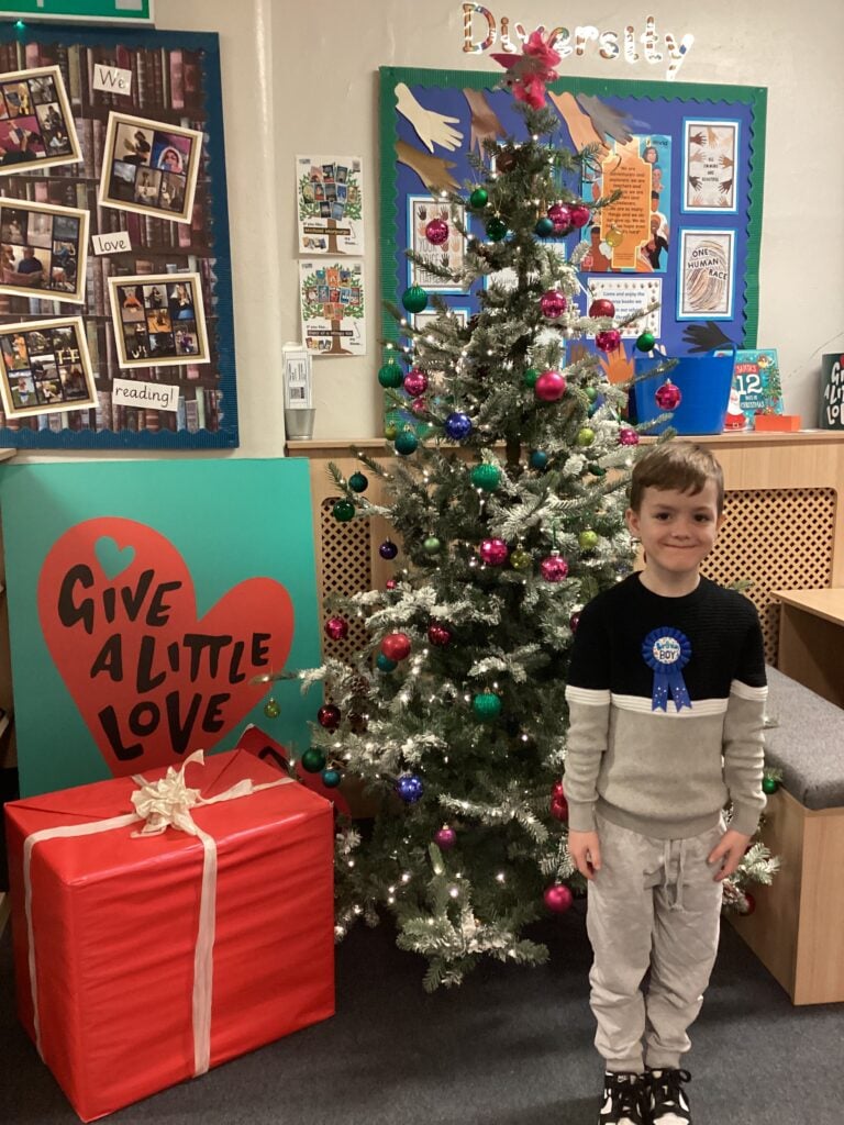 Child standing in front of a Christmas Tree