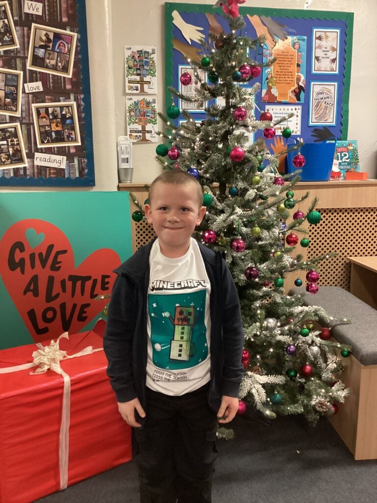 Child standing in front of a Christmas Tree