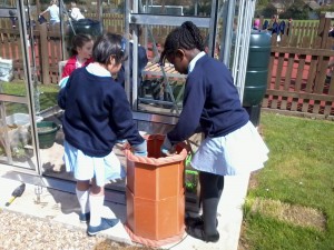 Maticia and Ju-Eun using the potato planters