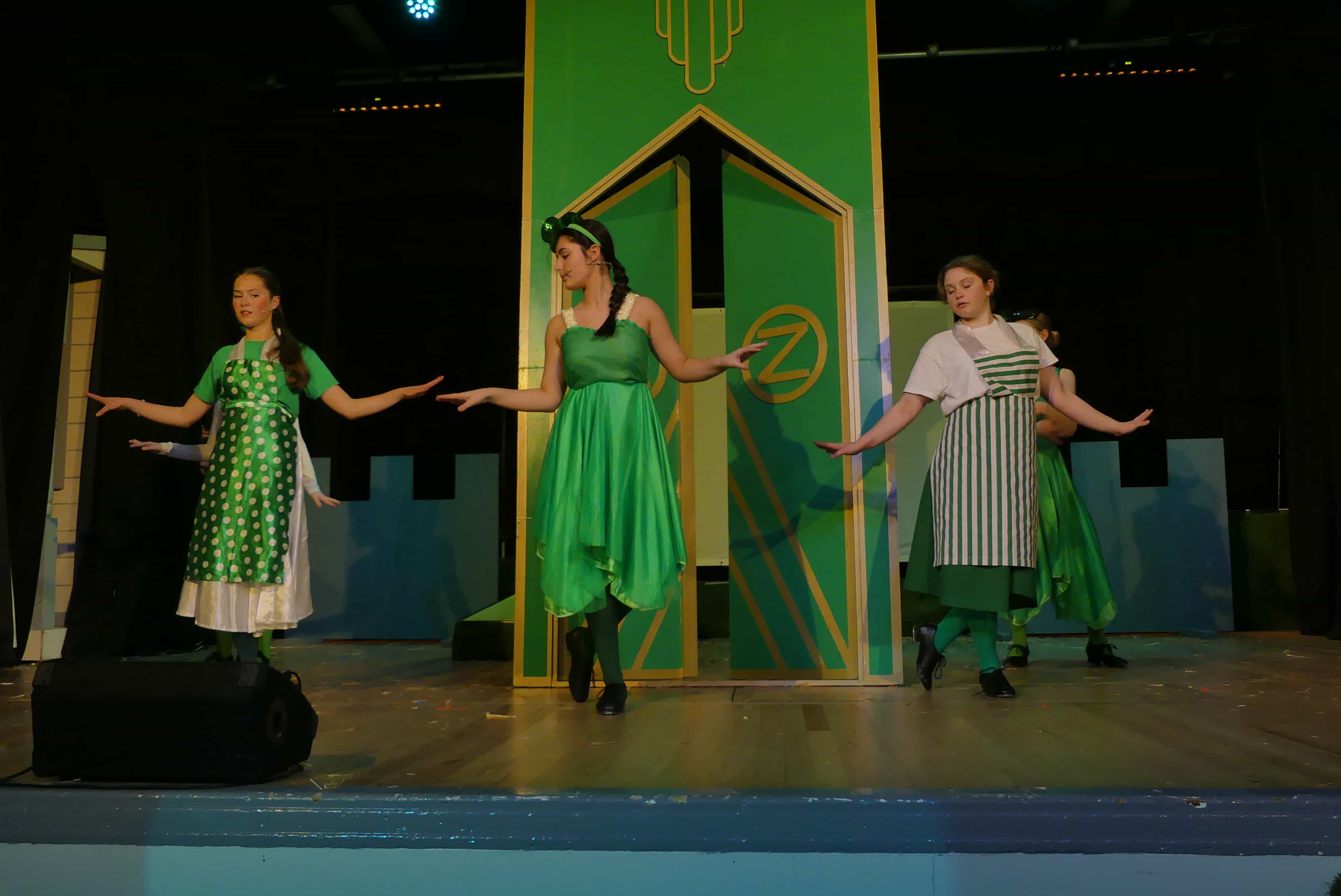 Students dance in the emerald city in the Hazel Grove High School production of the Wizard of Oz, 2024.