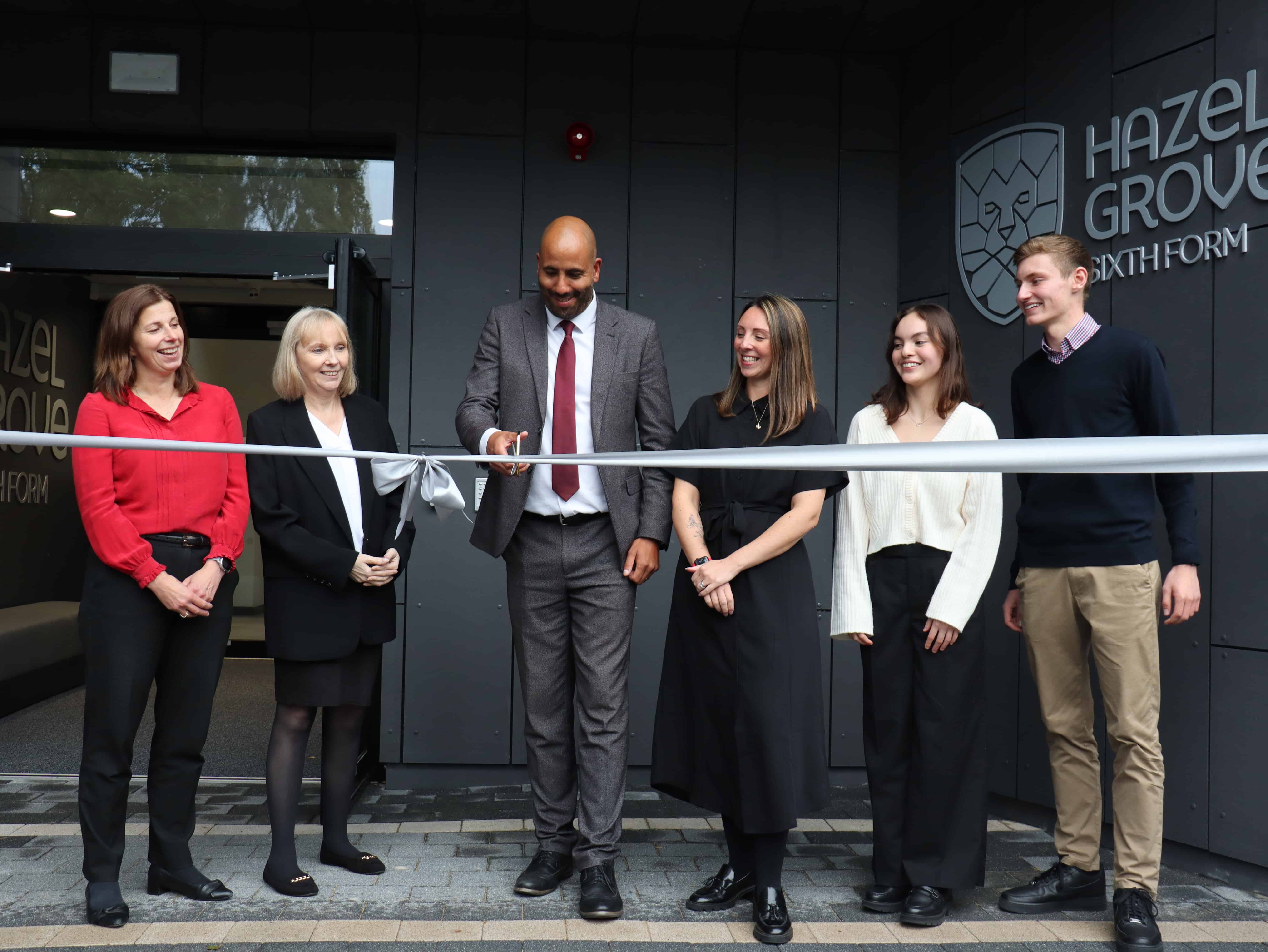 Laurus Trust CFO Wendy Mason, CEO Linda Magrath, Hazel Grove High School Head of School Martin Stewart, Director of Sixth Form Jo Lambert and Sixth Form students Eliott and Lizzie cutting the ribbon, to officially open Hazel Grove Sixth Form.