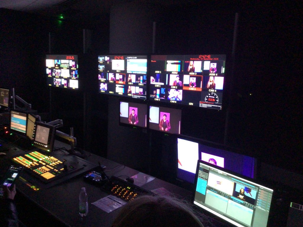 Various television screens show different camera angles of HGHS students in a studio at MediaCity.