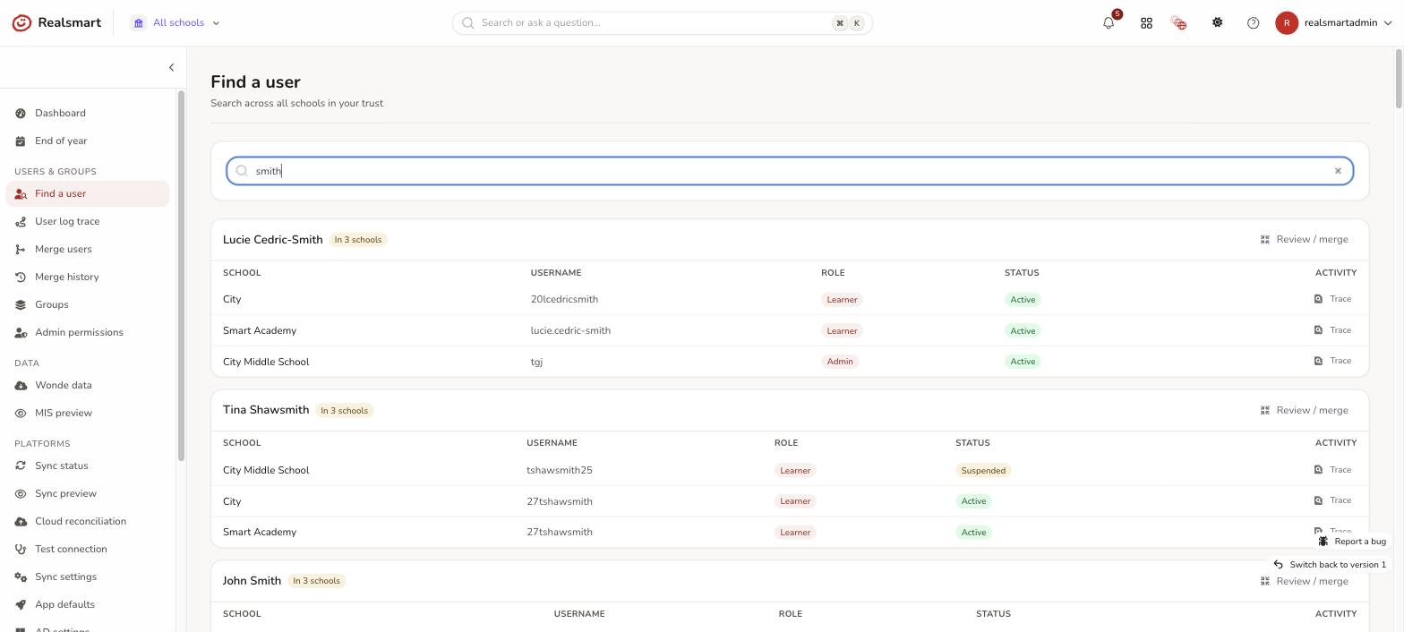 Find a user results grouped by person showing an In N schools badge with Review or merge and Trace buttons