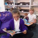 Children sat in library with Author Stuart Reid