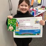 Child with certificate for reading planets challenge