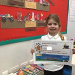 Child with certificate for reading planets challenge