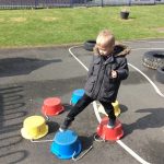Child walking on buckets
