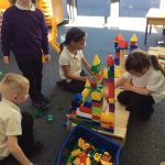 Children playing with large lego bricks