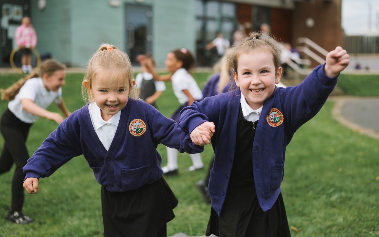 Two girls at William Leech smiling and running towards the camera