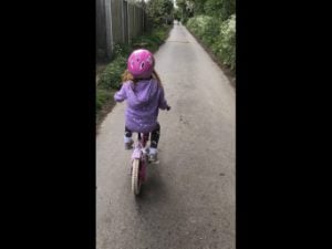 Riding a bike without stabilisers.