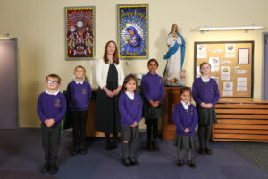 Our Lady Queen of Martyrs acting Headteacher Sophie Adams and deputy headteacher Hannah Elsworth with pupils