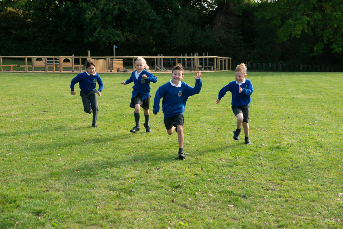 Pupils from Billingshurst Primary Academy running on the school field