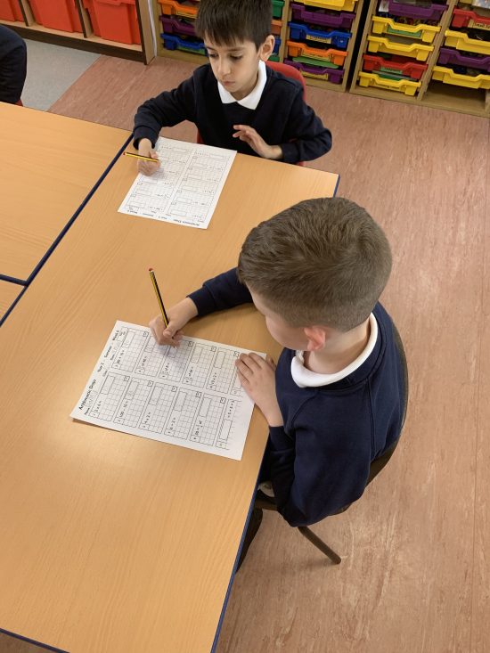 Children in Y2 working on their mental arithmetic test