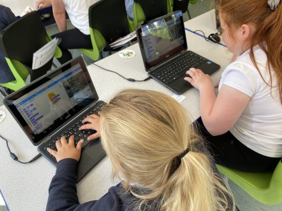 Children working on the new ASDA laptops to create an animation in Scratch