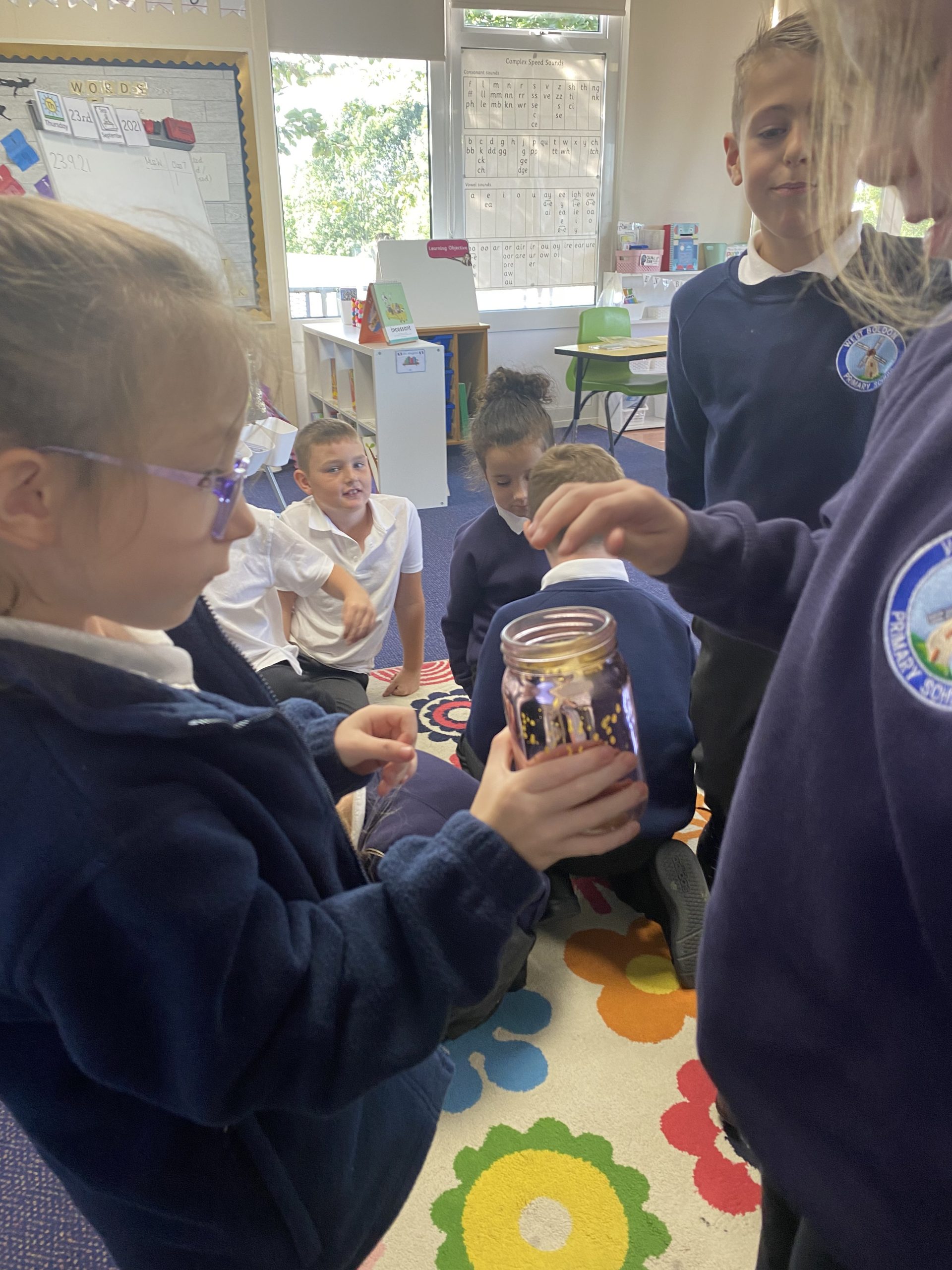 Year 3 putting their secrets in the secret jar