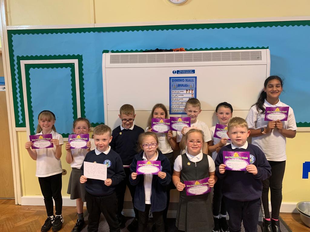 Children showing off their certificates