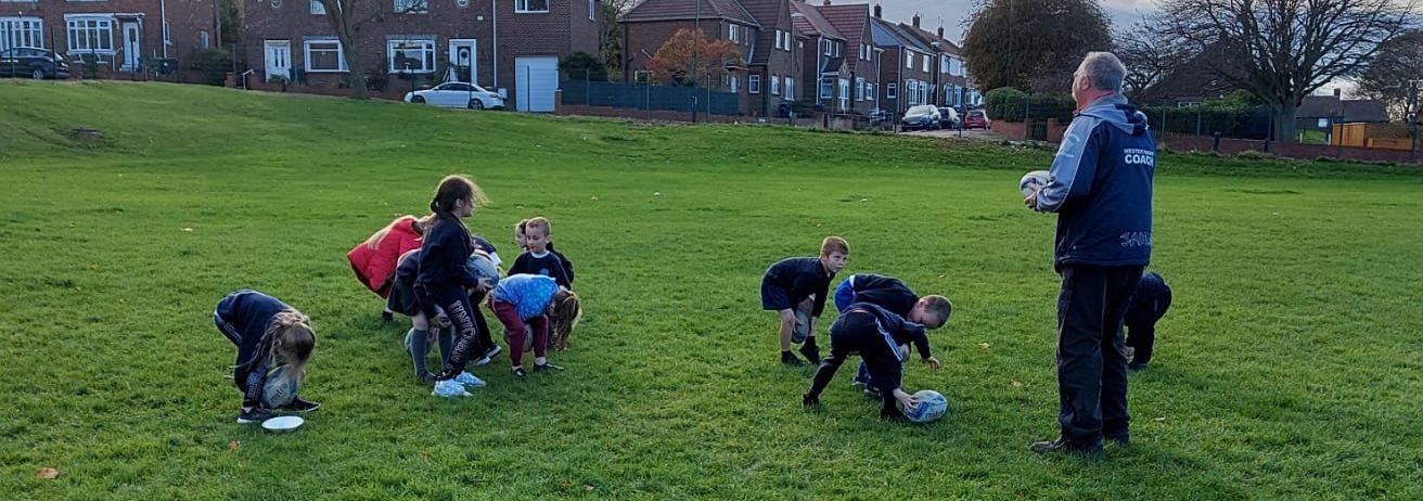 Year 2 playing rugby with John