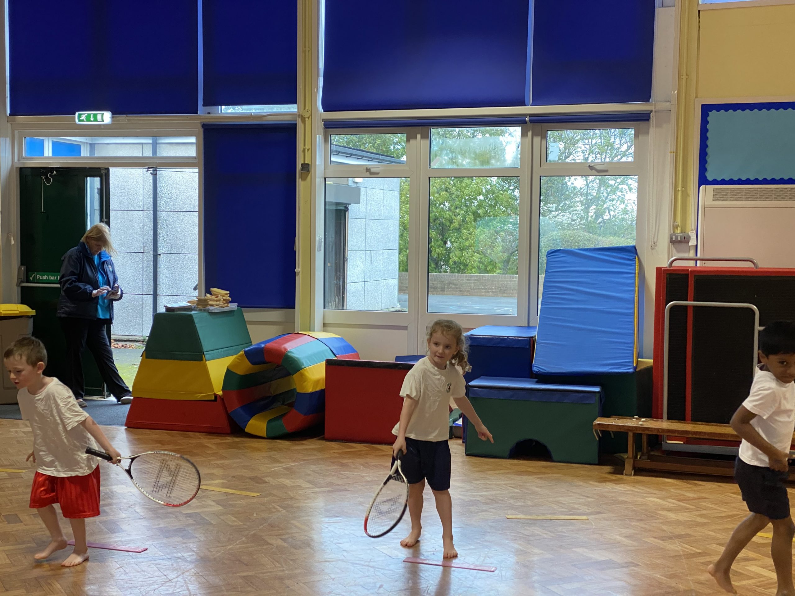 Year 1 taking part in their tennis coaching lesson