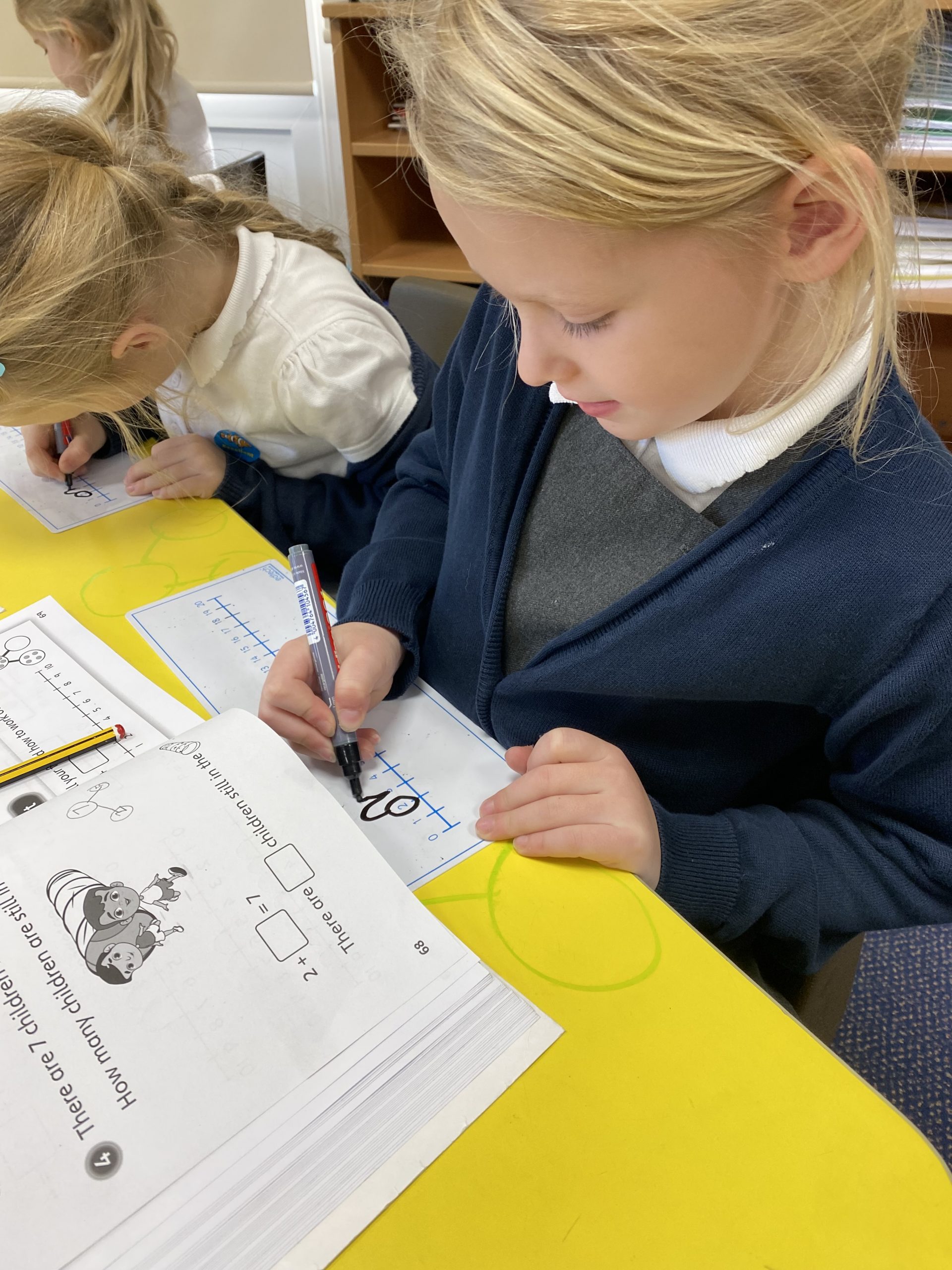 Year 1 children working in their Power Maths books
