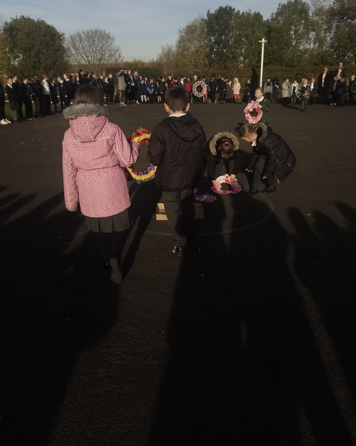 Children gathering to show their respect at 11am