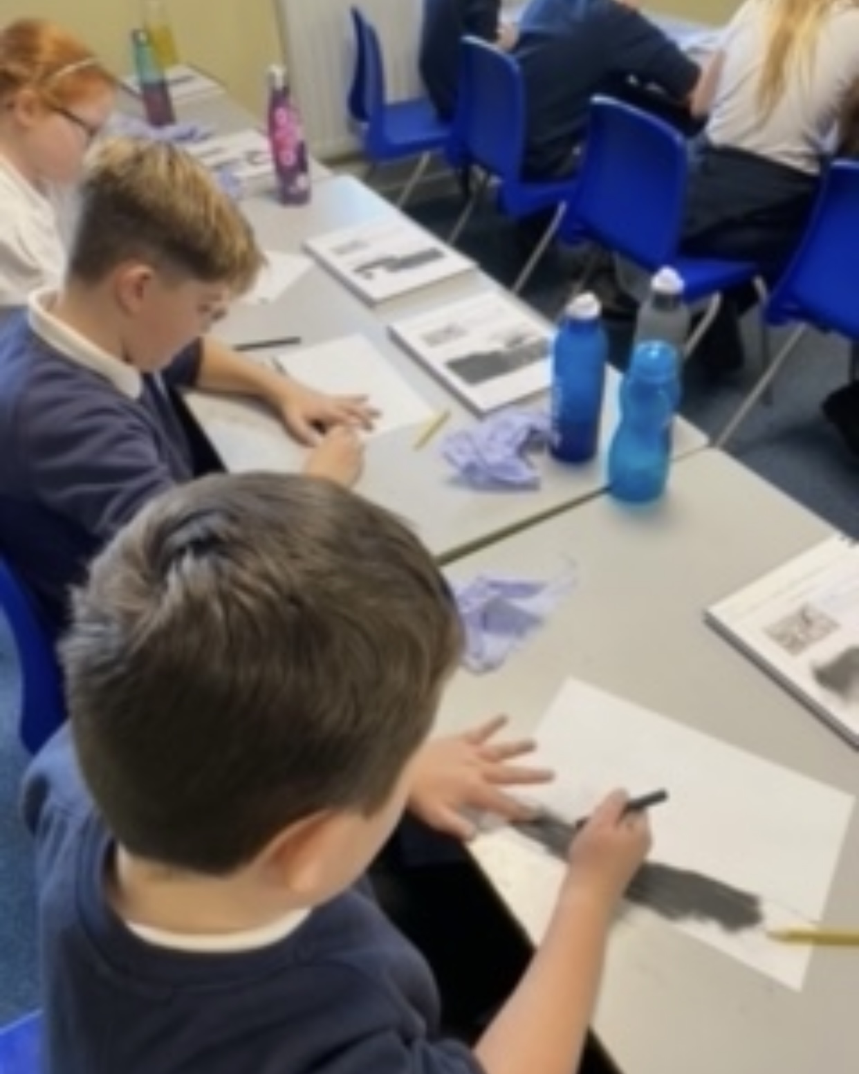 Children in Year 6 creating their charcoal drawings