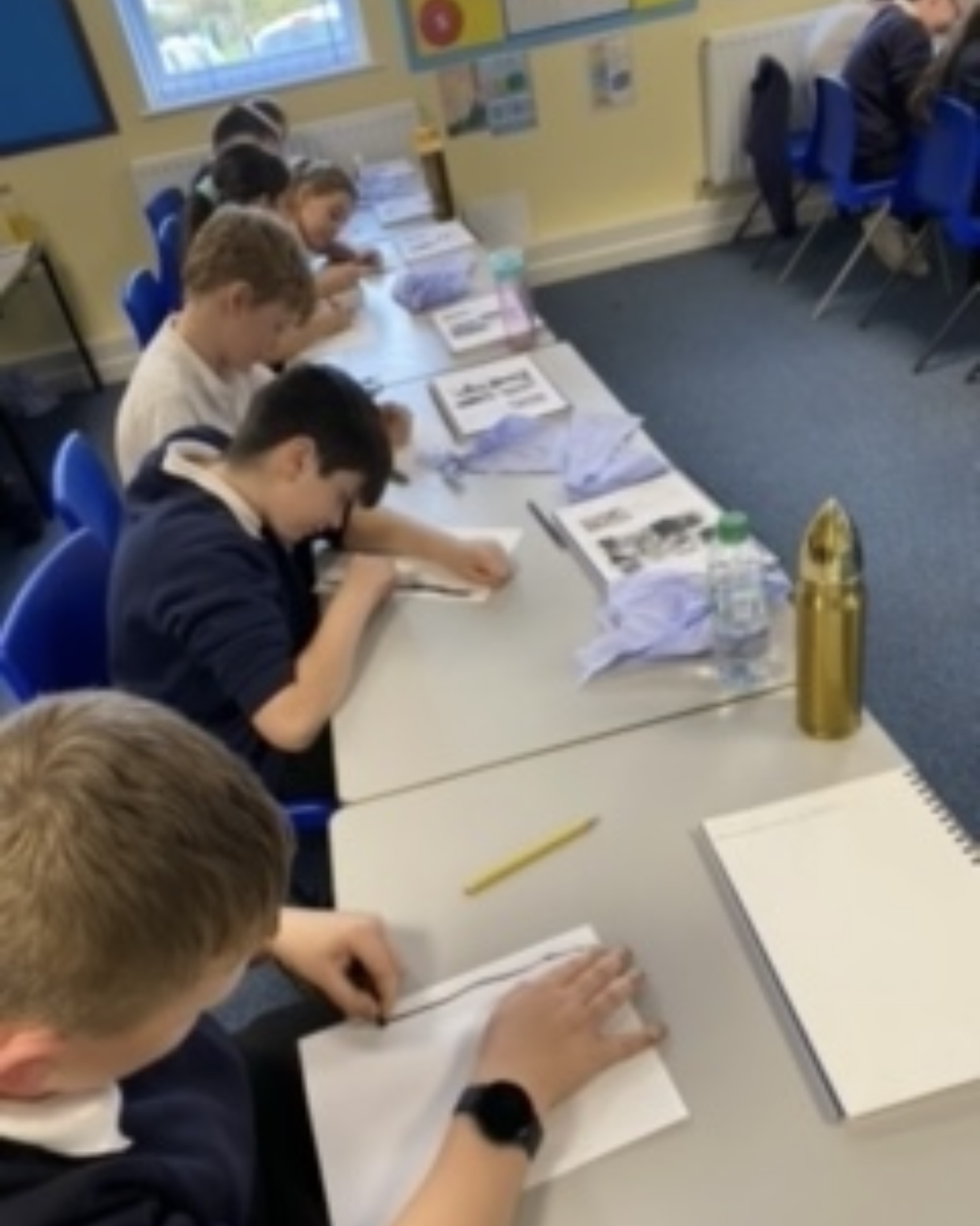 Children in Year 6 working on their charcoal drawings