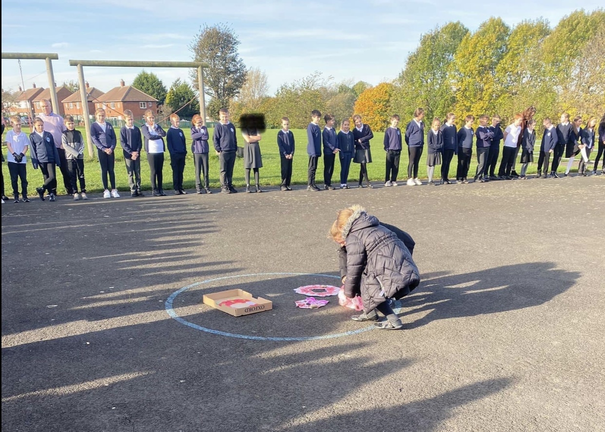 Children gathering to show their respect at 11am