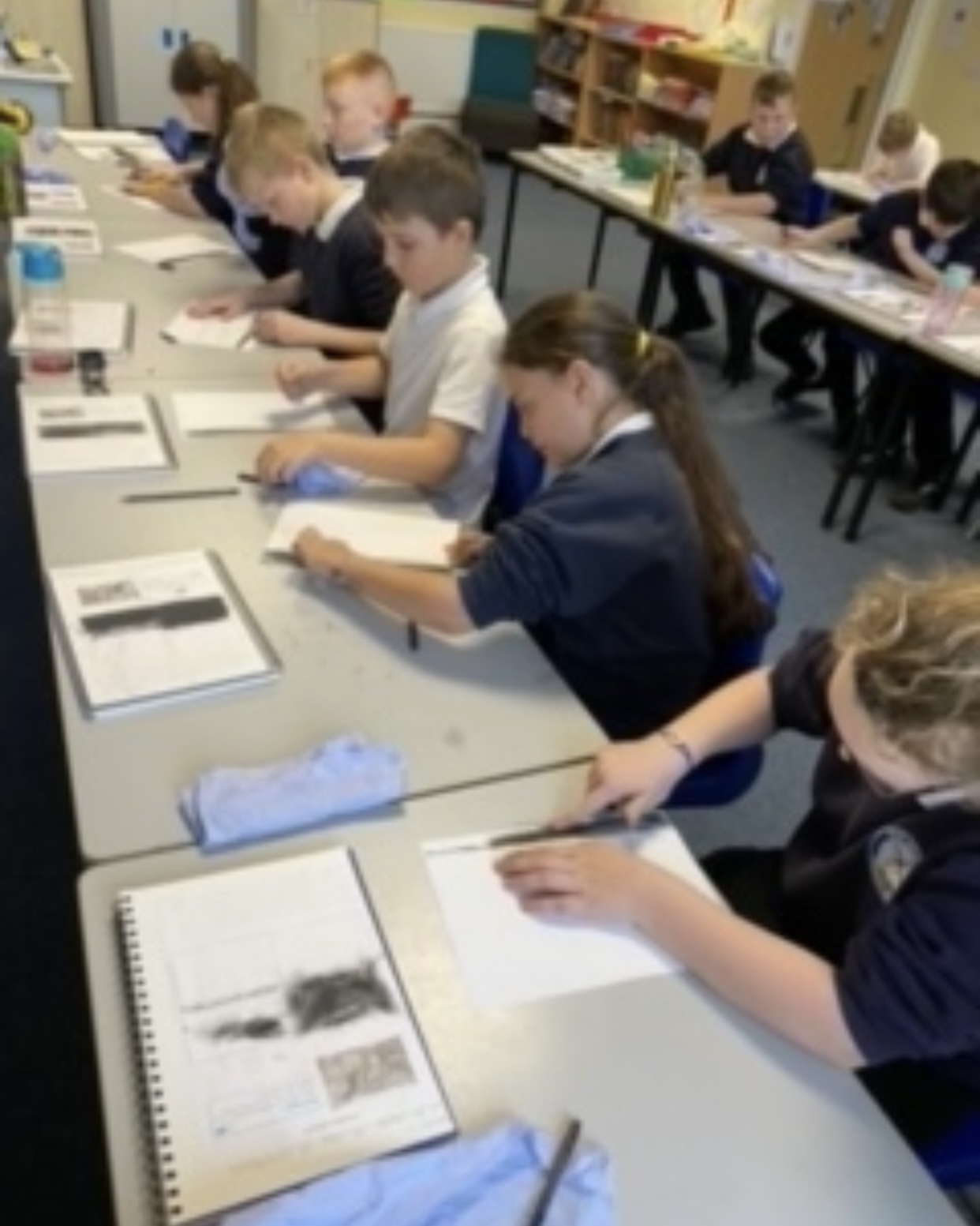 Year 6 children working on their charcoal drawings