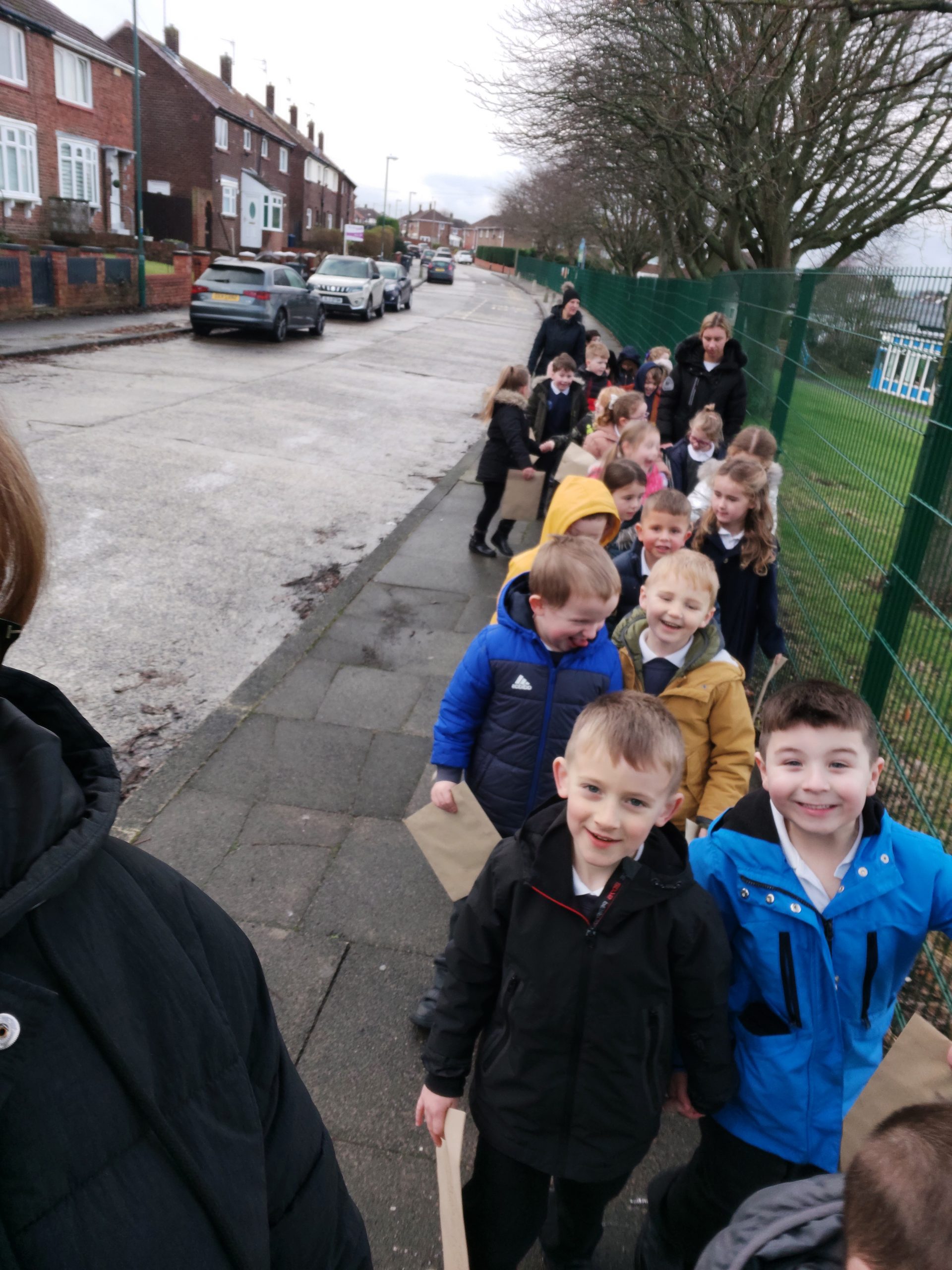 Year 1 children walking to the post box to post their letters to Santa Claus