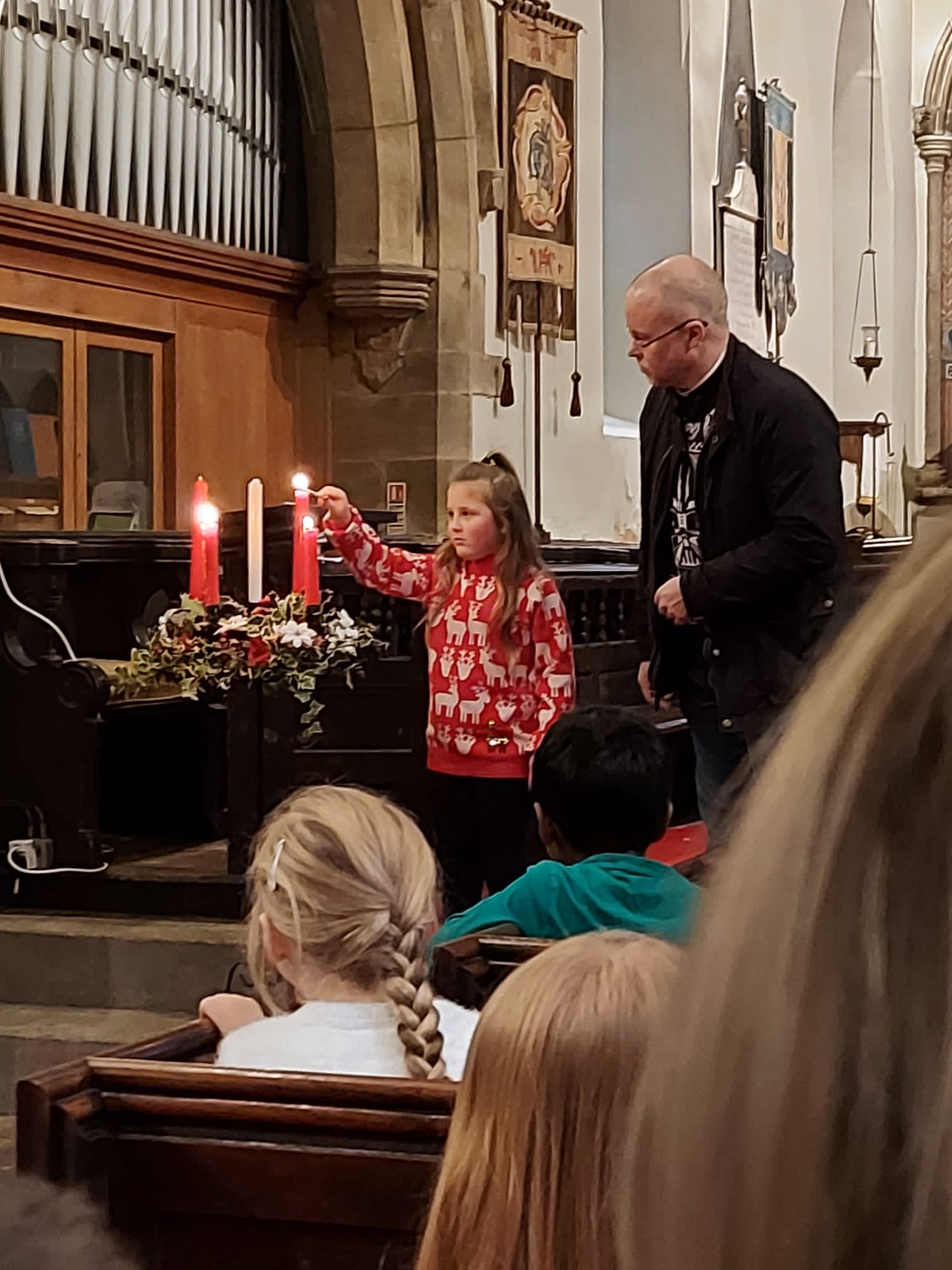 A child lighting the candles in Church