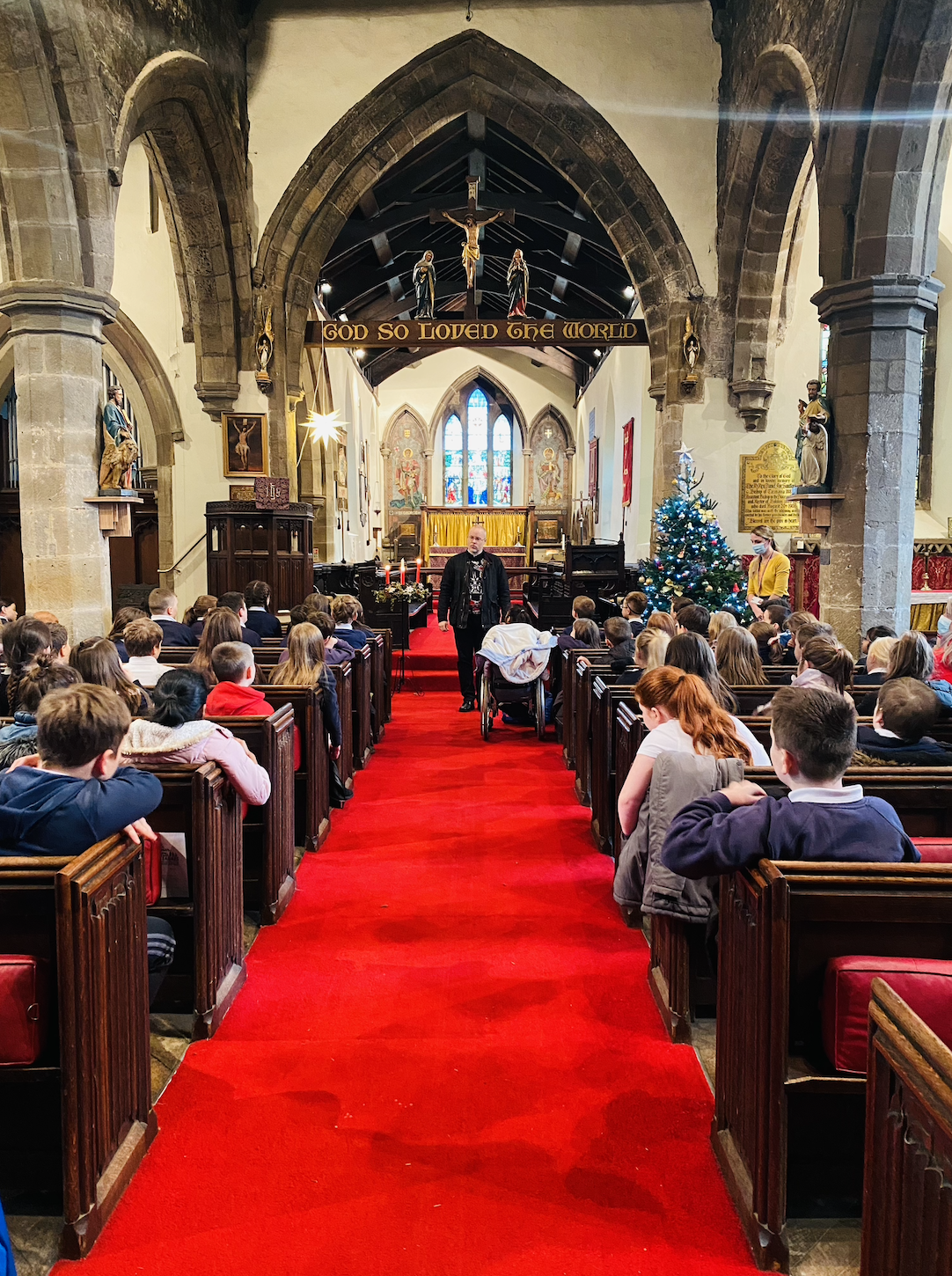 KS2 children listening to Rev. Paul