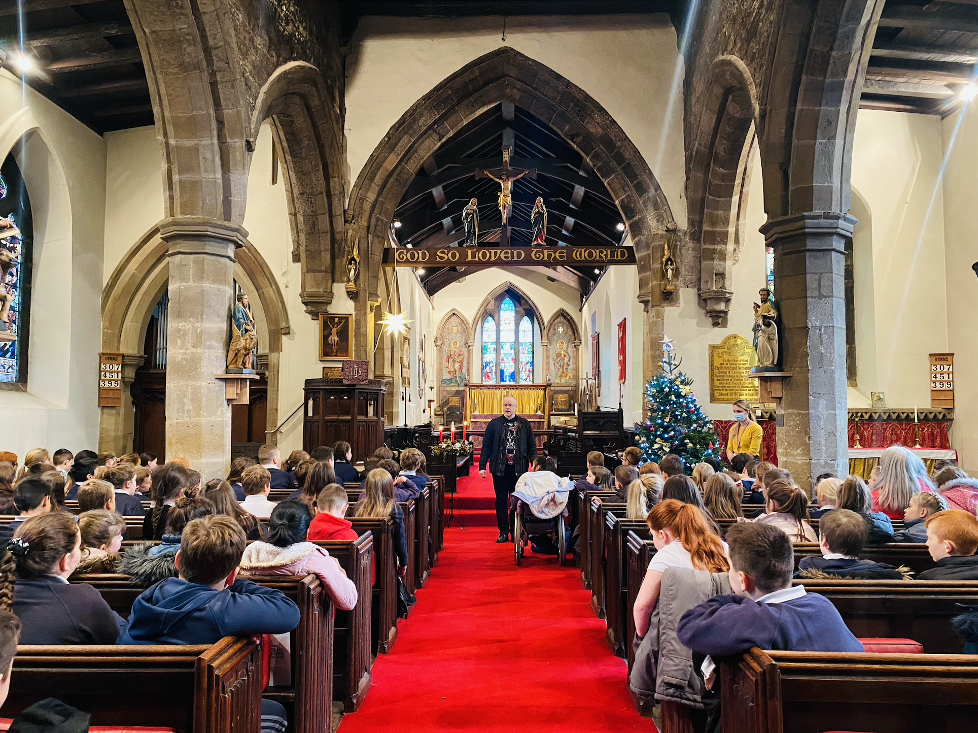 KS2 children listening to Rev. Paul