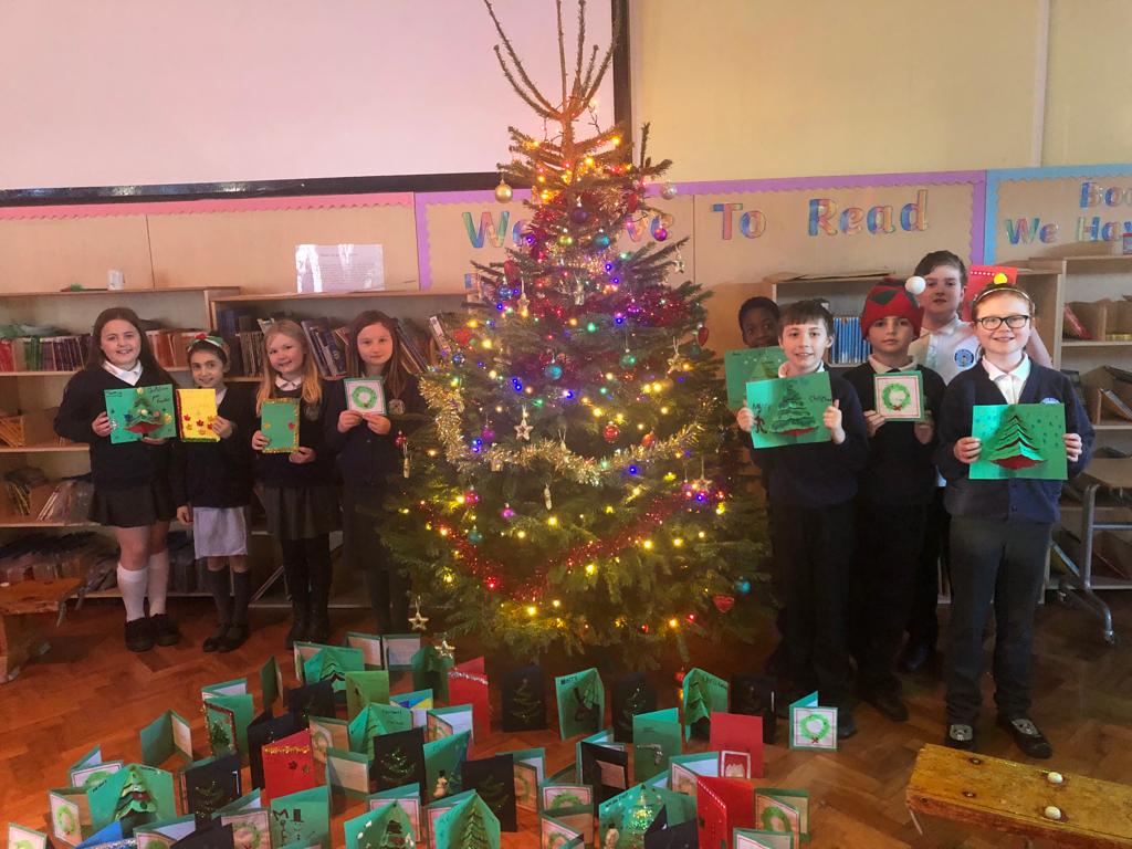 The children and their cards around the Christmas tree