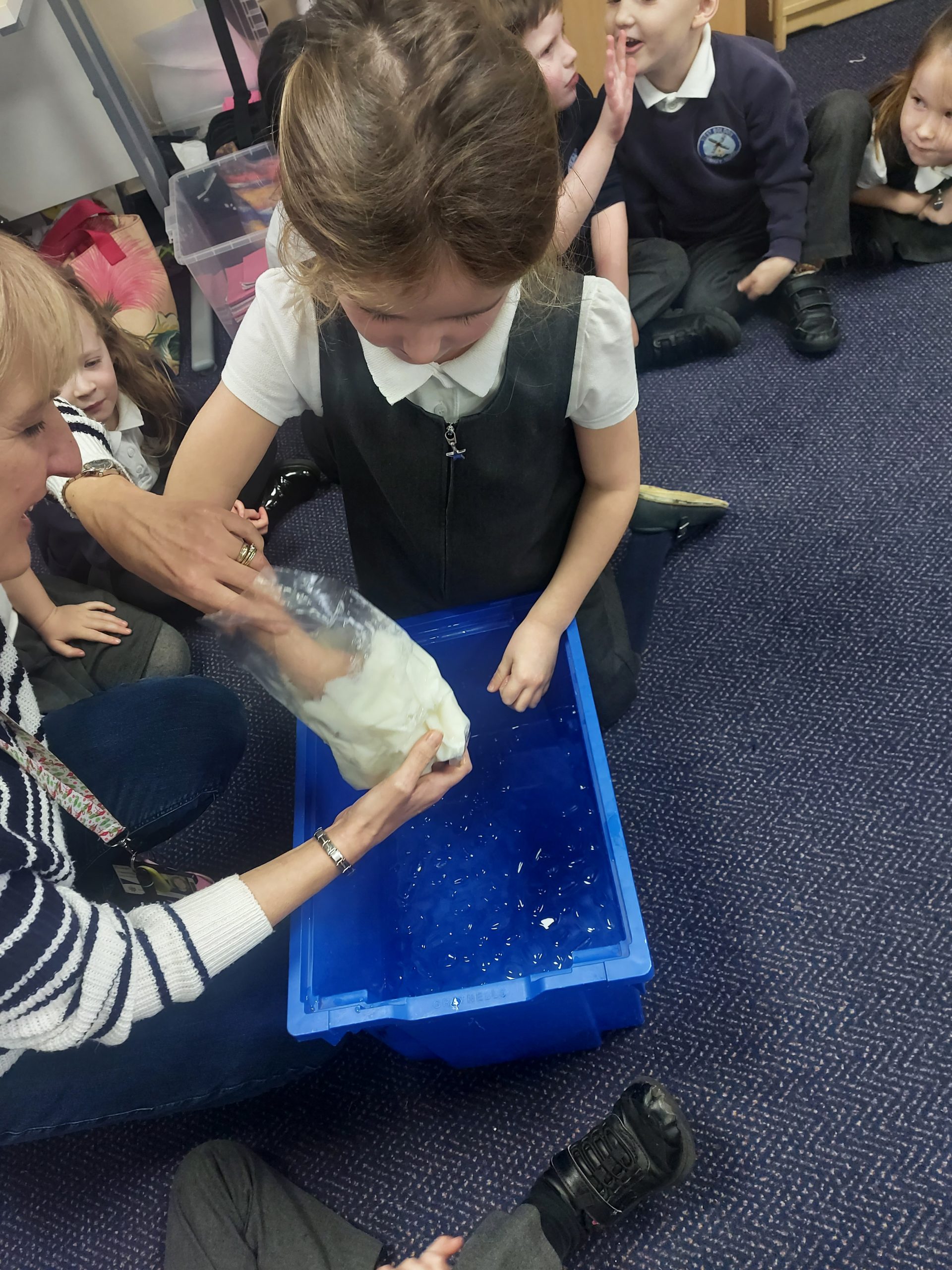 Year 1 children investigating how blubber works