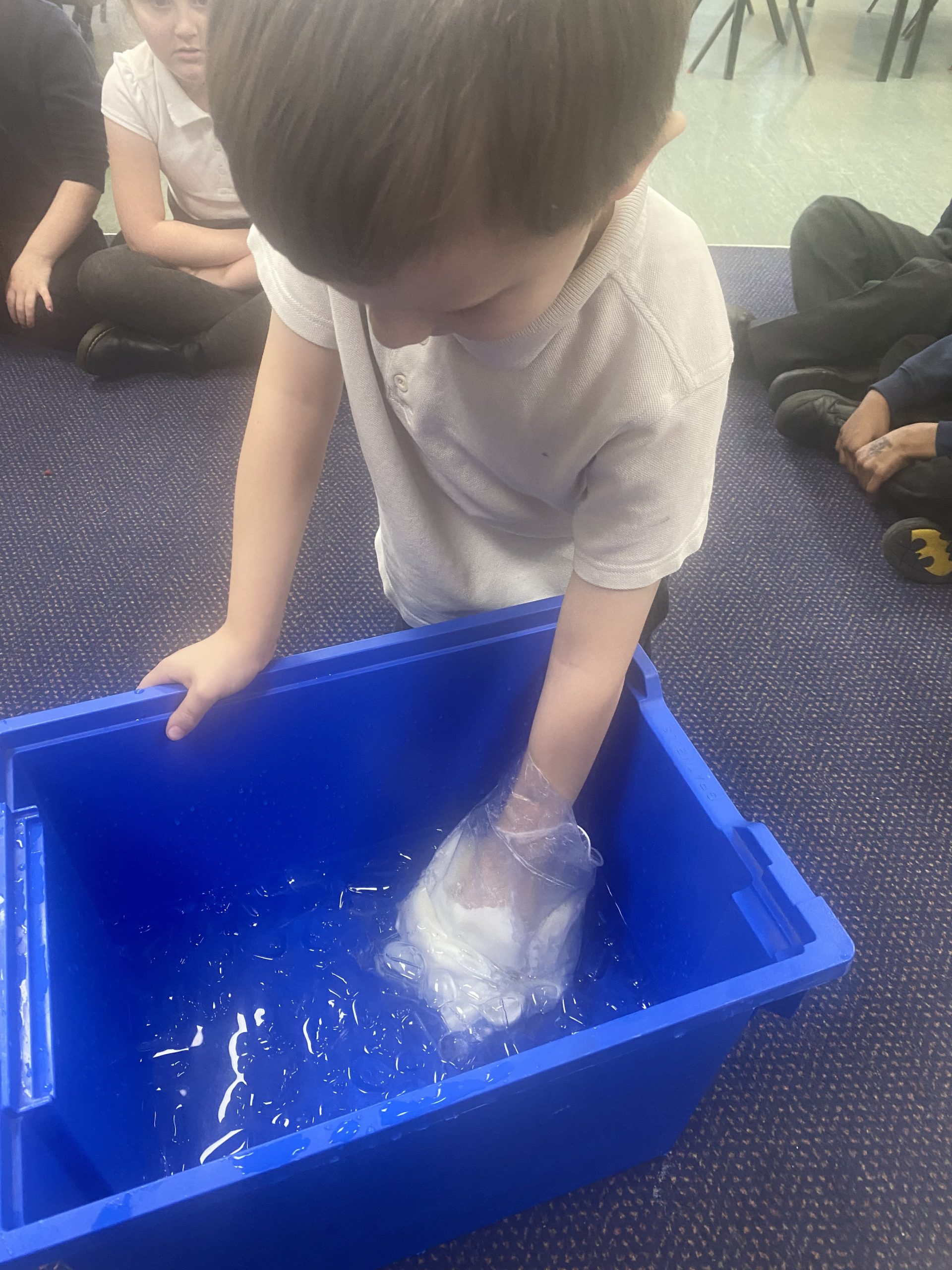 Year 1 children investigating how blubber works