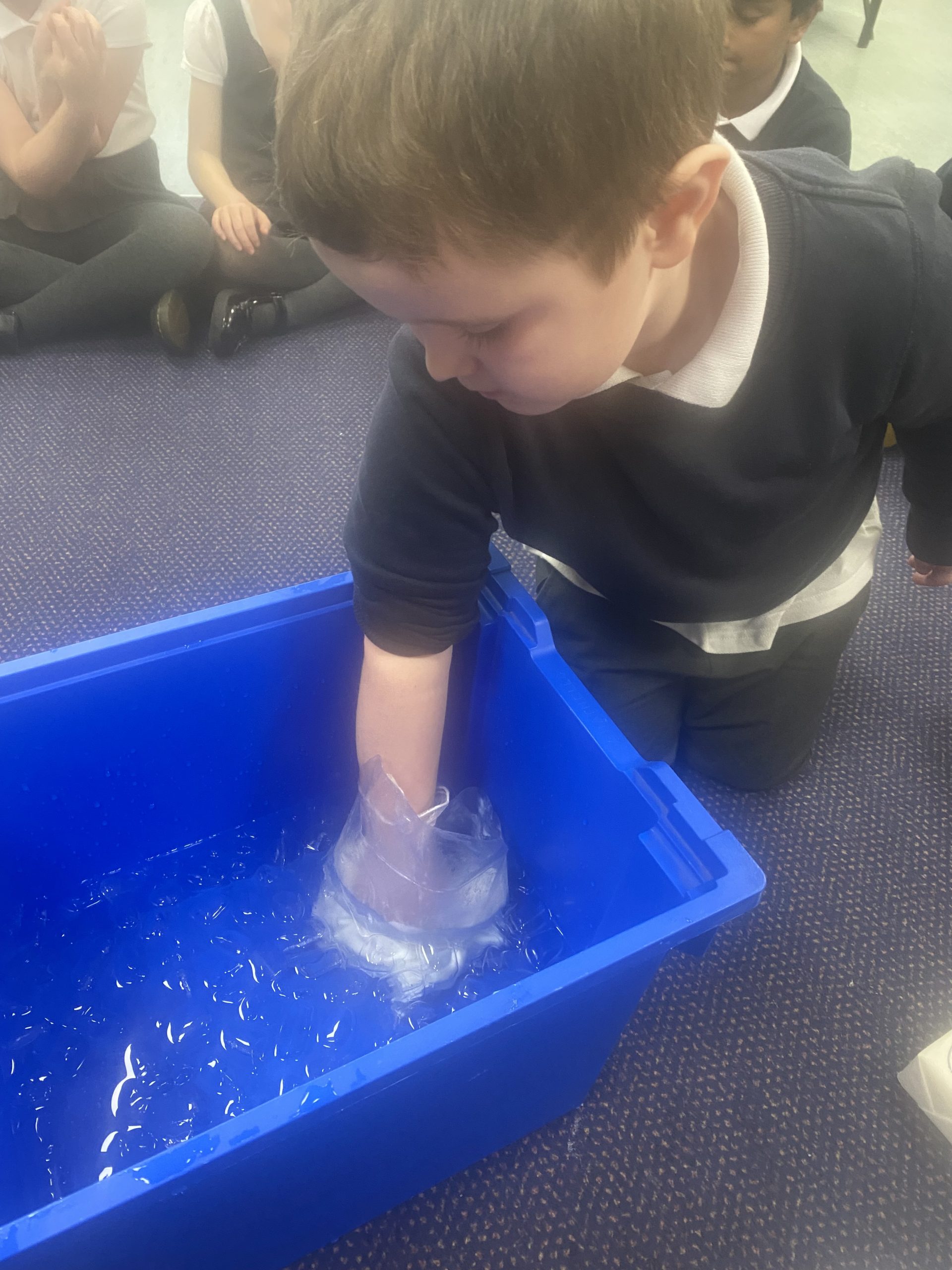 Year 1 children investigating how blubber works