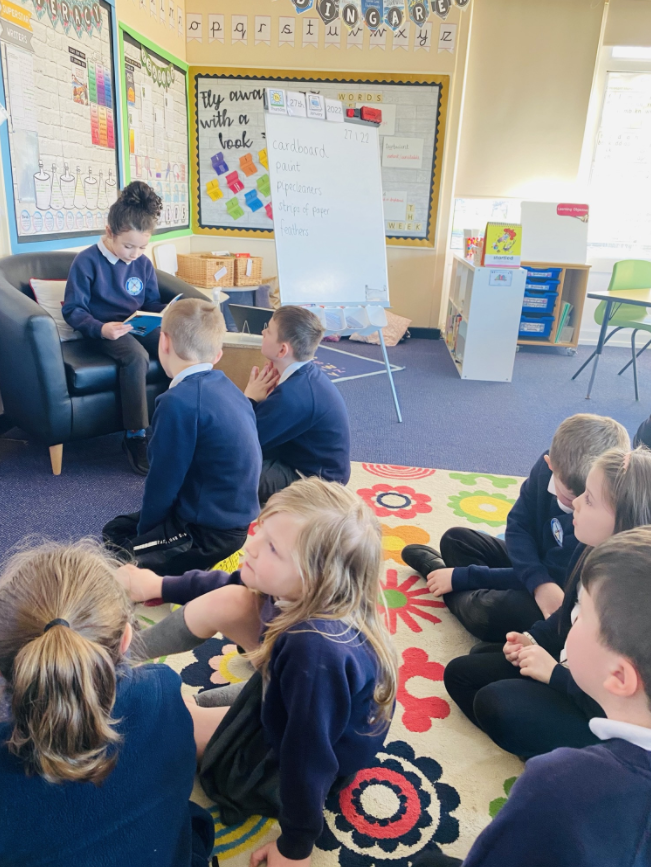 Year 3 child reading to the rest of the class